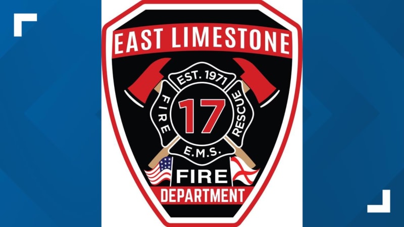 Firefighters and emergency vehicles at intersection during vehicle extrication rescue operation in Alabama