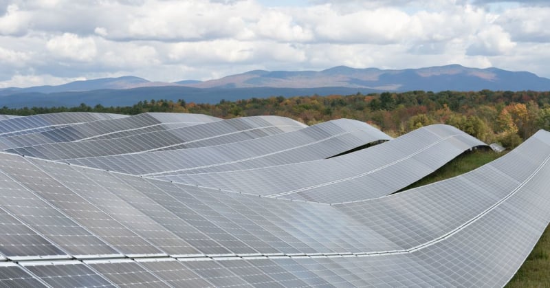 Large scale battery storage facility with rows of white storage containers on power grid