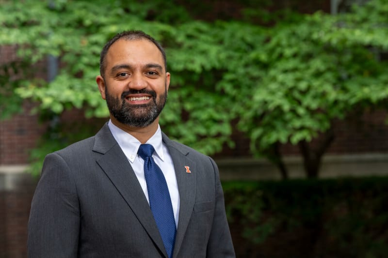 Professor Hanu Tyagi standing in front of University of Illinois campus building