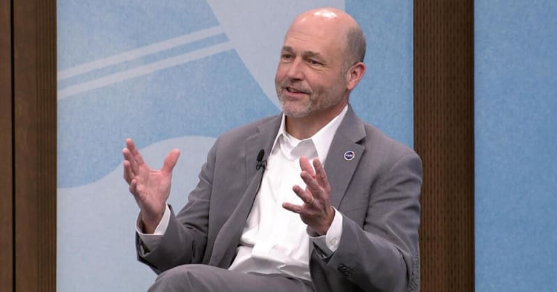 NASA Glenn Research Center building in Cleveland with American flag and space exploration equipment visible