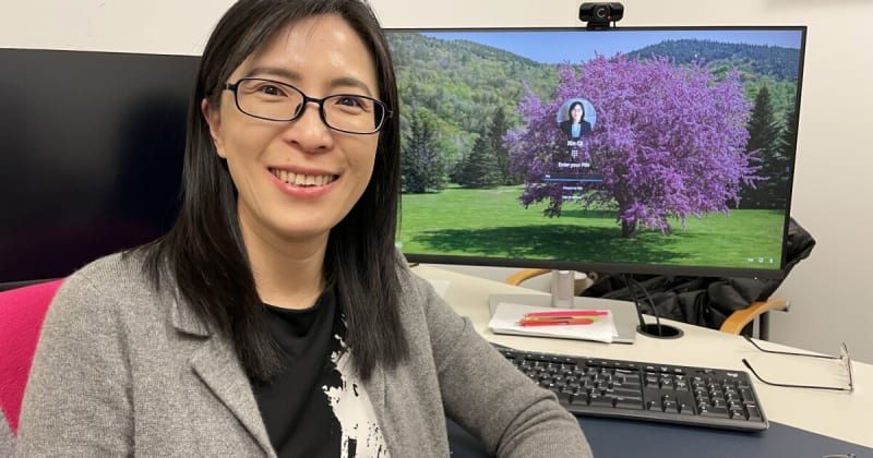 Researcher Xin Qi in laboratory studying molecular treatment for Parkinson's disease at Case Western Reserve