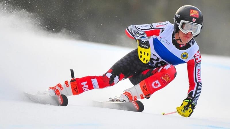 Para alpine skier Alexis Guimond racing downhill in standing position on snowy course in Austria