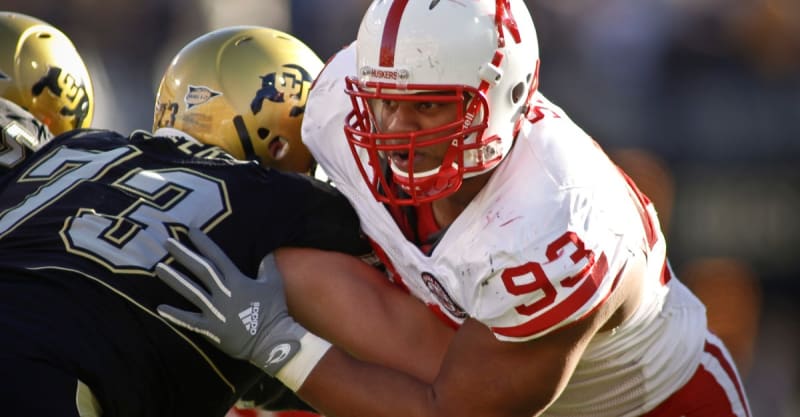 Herman Moore and Ndamukong Suh in their Detroit Lions uniforms celebrating on the field