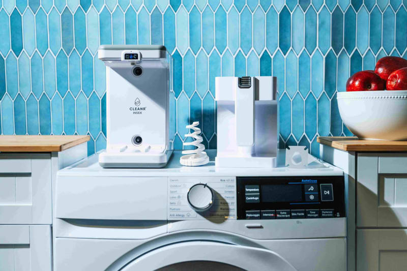 Cleanr washing machine filter device sitting atop standard household washer capturing microplastic fibers