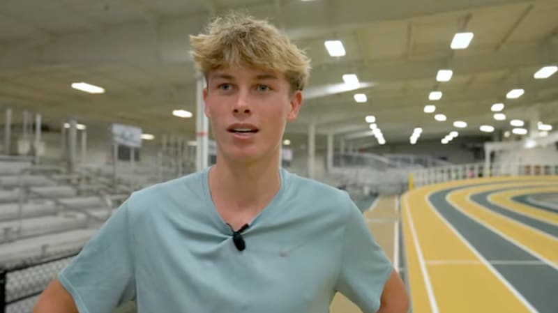 Young runner Sam Ruthe competing on indoor track in racing uniform