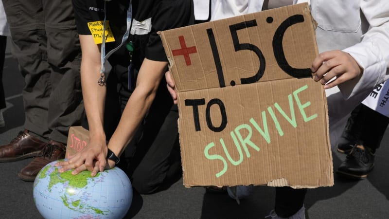 Woman cooking on efficient wood-burning cookstove with minimal smoke in Myanmar home