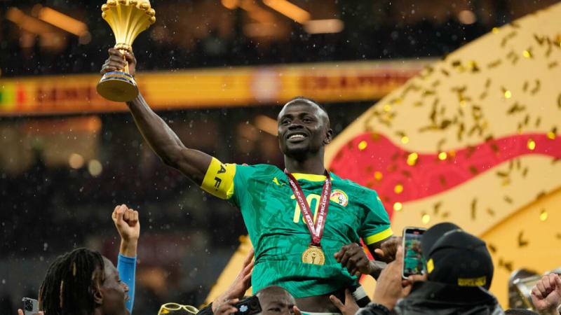 Senegal's Sadio Mane holds the Africa Cup of Nations trophy after defeating Morocco in Rabat