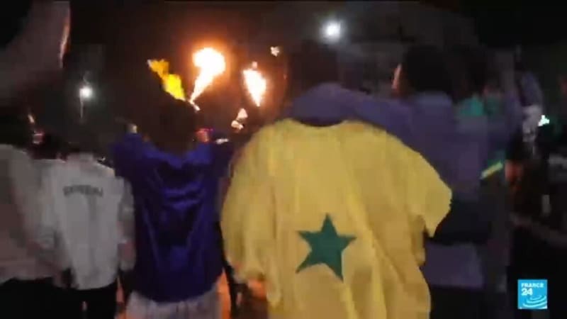 Senegalese soccer fans celebrate in Dakar streets waving flags after AFCON championship win