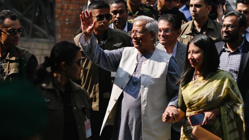 Muhammad Yunus waving to supporters after voting in Dhaka polling center, February 2026