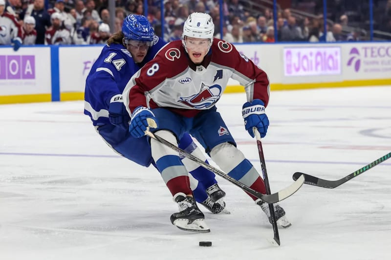Colorado Avalanche players celebrating on ice during NHL game against Tampa Bay Lightning in exciting matchup