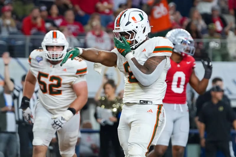 FOX sports presenter Andy Slater celebrating with Miami Hurricanes betting slip showing potential $50,500 payout during College Football Playoff run