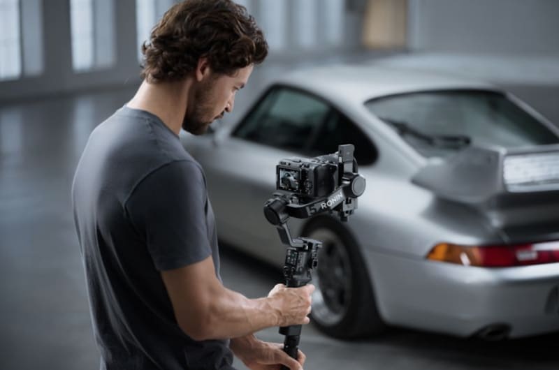 DJI RS 5 camera gimbal with mounted mirrorless camera and touchscreen tracking display