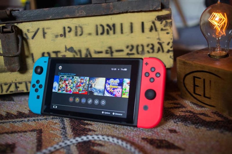Nintendo Switch console showing gaming screen with colorful Joy-Con controllers attached