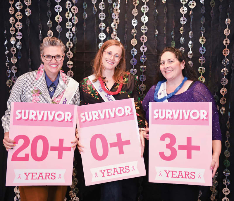Cancer survivors and caregivers gathering at community celebration dinner with decorated tables