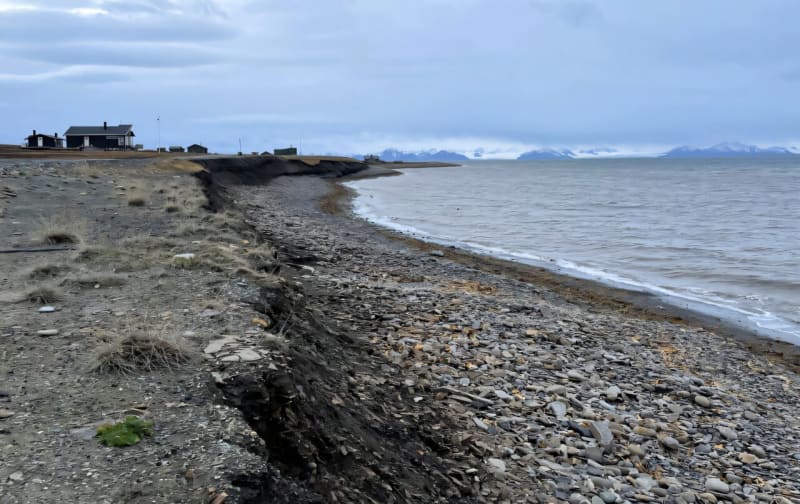 Coastal erosion along Svalbard's Arctic shoreline with researchers studying vulnerable beaches