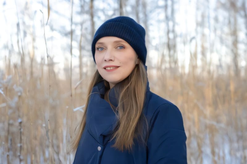 Person swimming in cold lake water surrounded by winter landscape and natural beauty