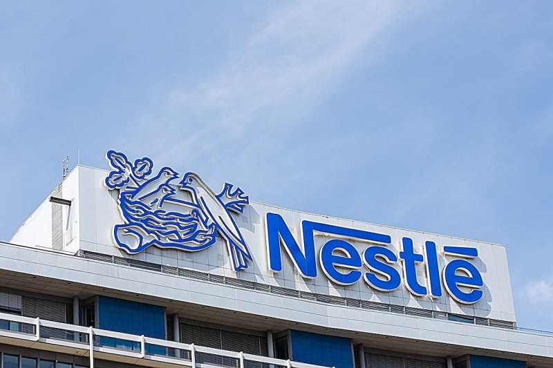 Happy, healthy baby being held lovingly by parent, representing infant safety and protective care in modern nutrition