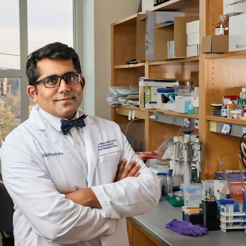 Medical researcher Dr. Madhav Menon in laboratory setting studying kidney disease genetics and treatment approaches