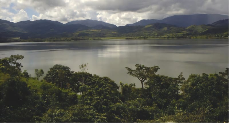 Lake La Yeguada in Panama surrounded by lush green tropical forest and hills