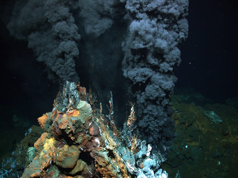 Deep-sea hydrothermal vent releasing mineral-rich water where early life may have emerged billions of years ago