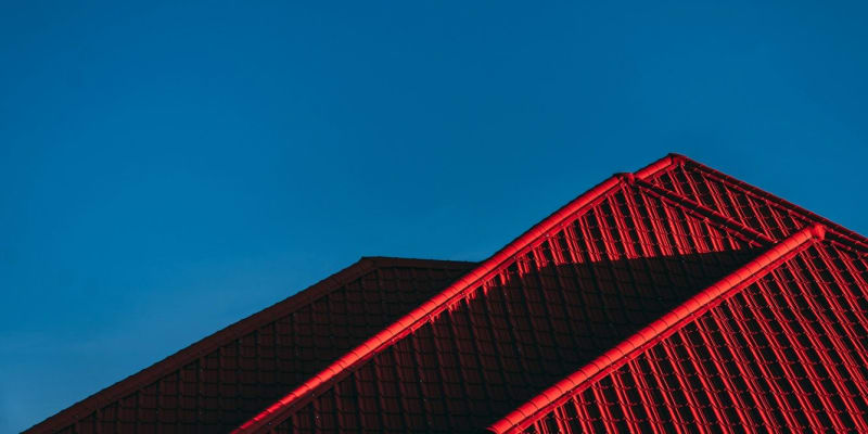 Modern home with innovative smart roofing materials reflecting sunlight while maintaining comfortable indoor temperatures naturally