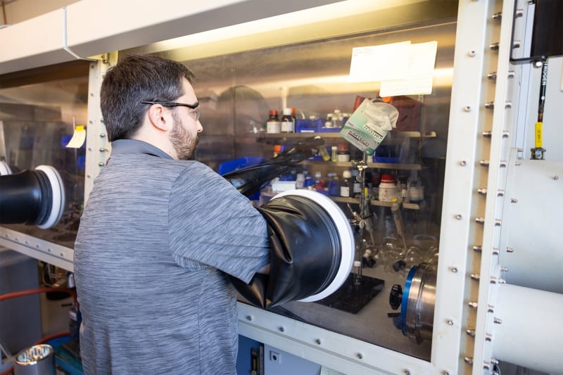 Scientist working with laboratory equipment conducting clean energy fuel cell catalyst research at Yale University