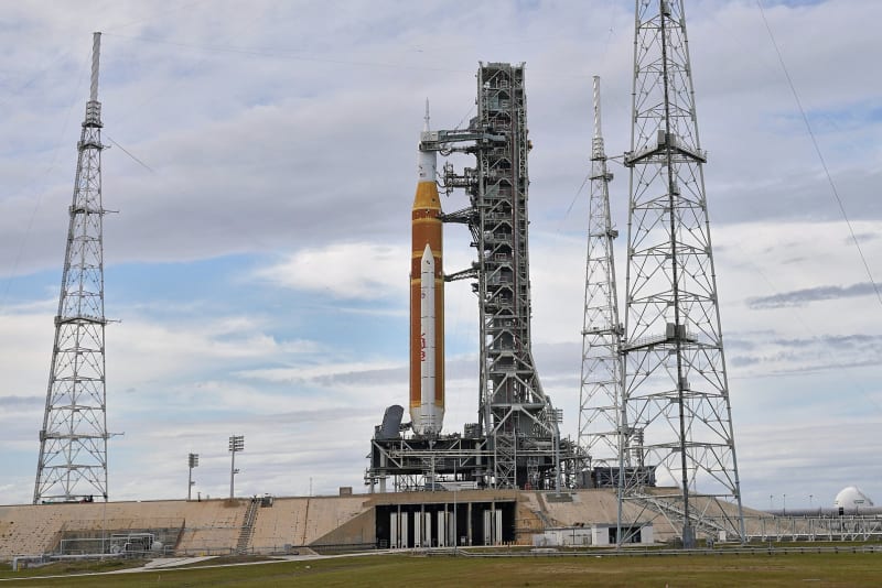 NASA's towering Space Launch System rocket stands illuminated on the launch pad at Kennedy Space Center