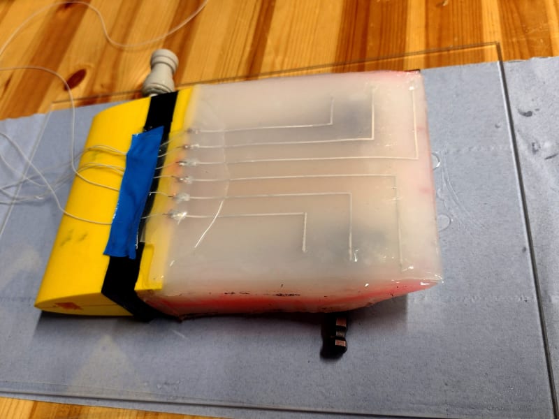 Flexible robotic wing with electronic sensing skin being tested in water tank