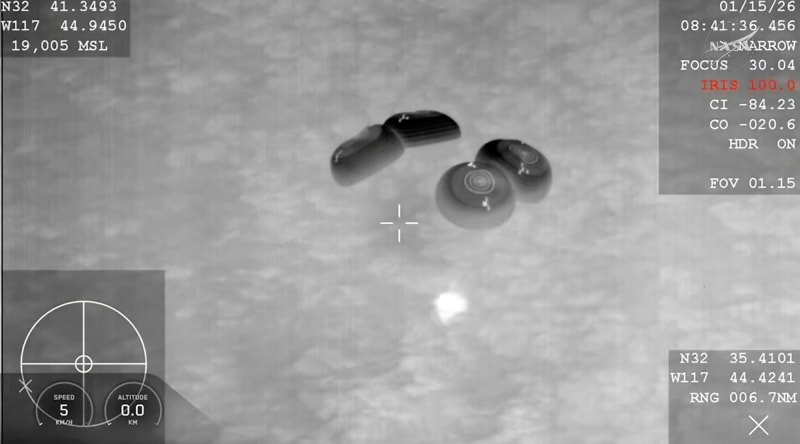 SpaceX Crew Dragon capsule floating in ocean after predawn splashdown with recovery teams nearby