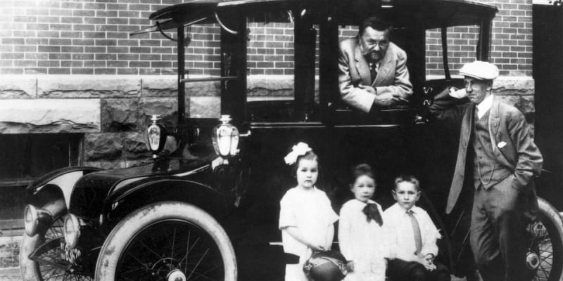 ** Charles Proteus Steinmetz leaning from window of 1914 Detroit Electric sedan with passengers