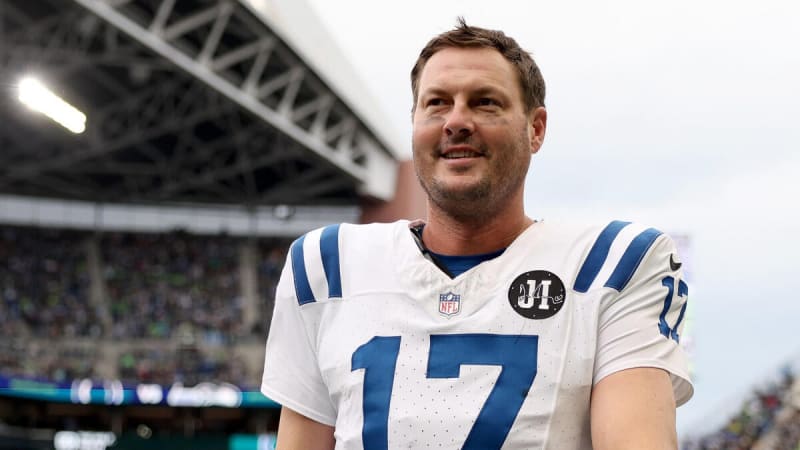 Philip Rivers in coaching attire on sideline, displaying leadership and knowledge during football game