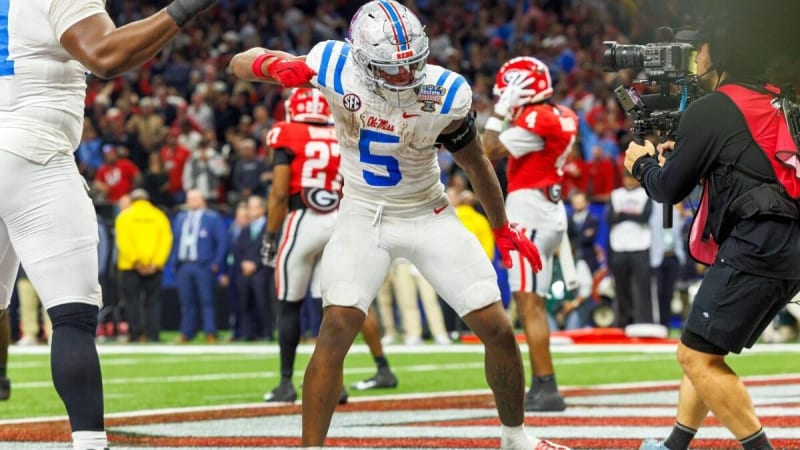 Ole Miss football coach Pete Golding celebrating with players and fans after major playoff victory