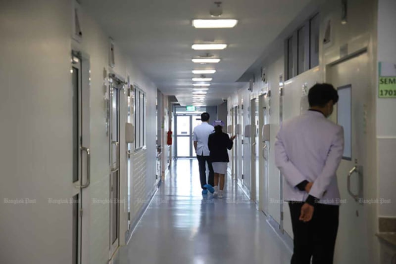 Medical professionals at Thai hospital preparing screening station for disease prevention protocols