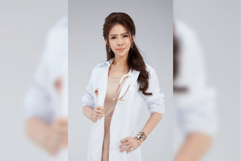 Dr. Khongkwan Fujitnirun holding her medical license outside Thailand's Medical Council offices in Bangkok