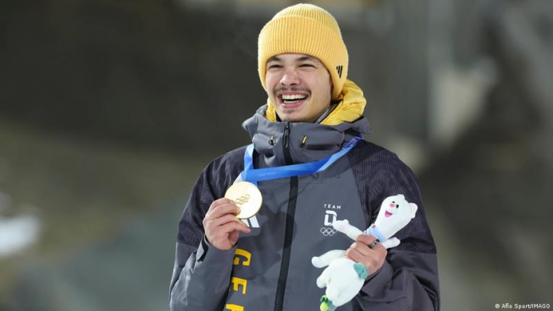 German ski jumper Philipp Raimund celebrating his Olympic gold medal victory in Predazzo