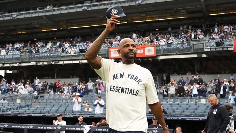 CC Sabathia in Yankees pinstripes celebrating after winning 2009 World Series championship