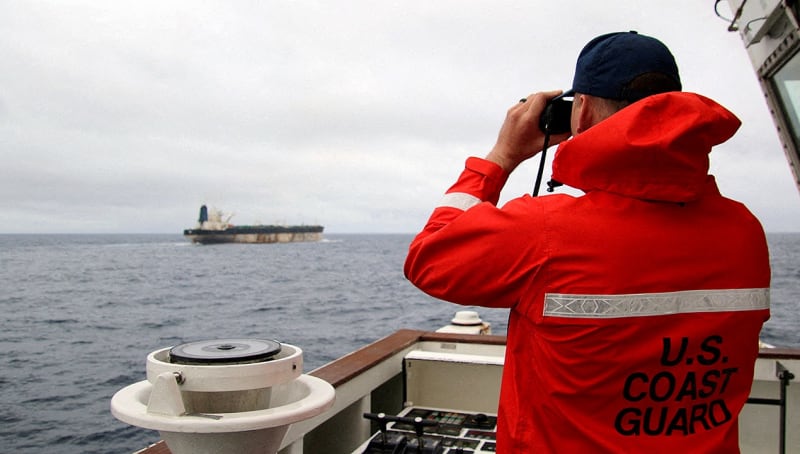 U.S. Coast Guard members in uniform standing at attention during official ceremony