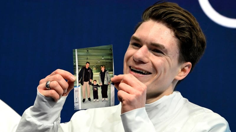 Maxim Naumov holds childhood photo with his parents after Olympic figure skating performance