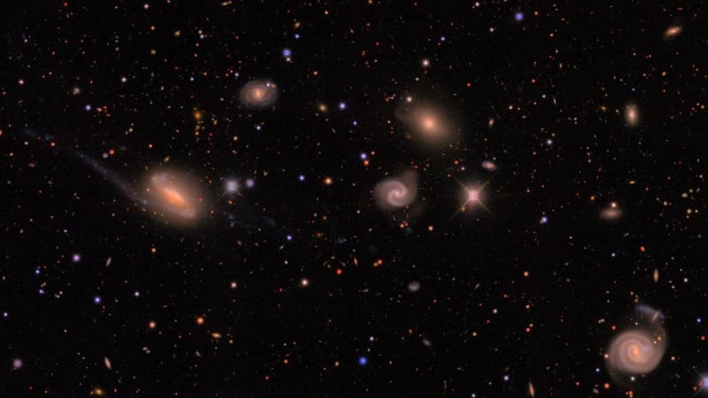** Telescope view of millions of distant galaxies scattered across dark space from Dark Energy Survey