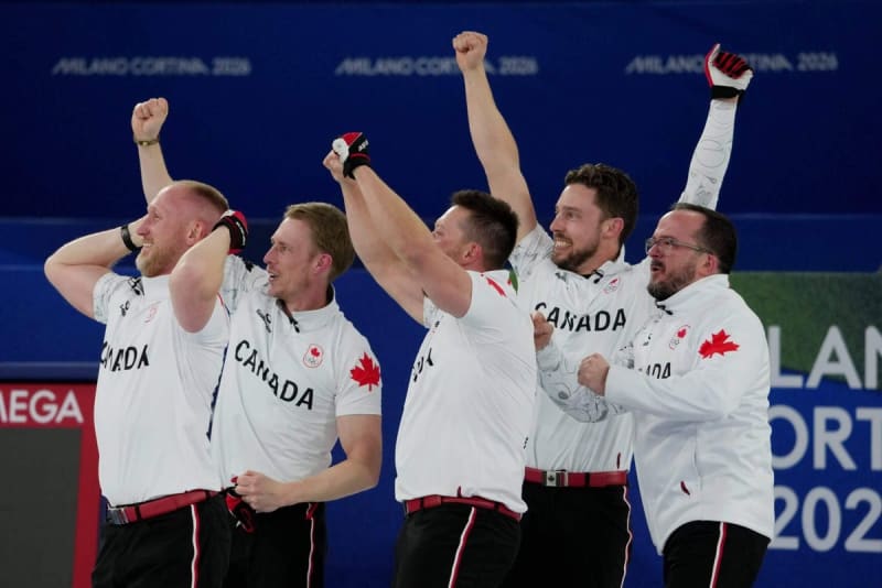 Norwegian cross-country skier Johannes Klæbo celebrates with arms raised crossing finish line winning sixth gold medal