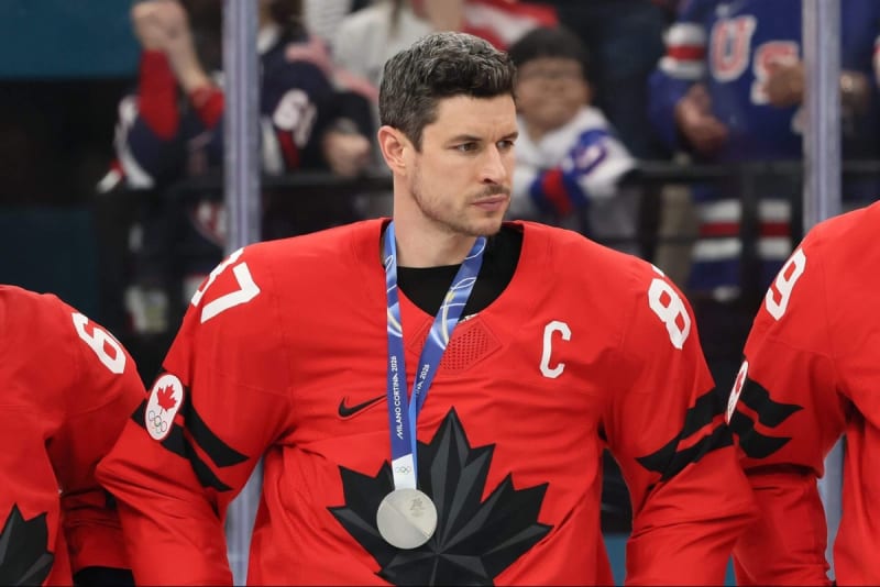 Sidney Crosby in Team Canada jersey standing with teammates on ice at 2026 Olympics