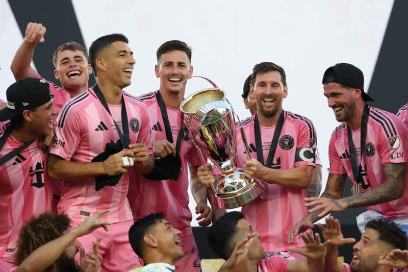 Inter Miami players celebrating with MLS Cup trophy after defeating Vancouver Whitecaps