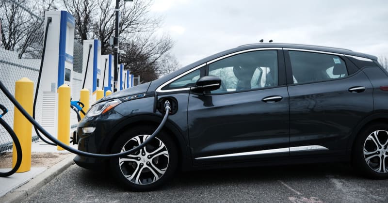 Electric vehicle charging at public fast-charging station in urban neighborhood setting