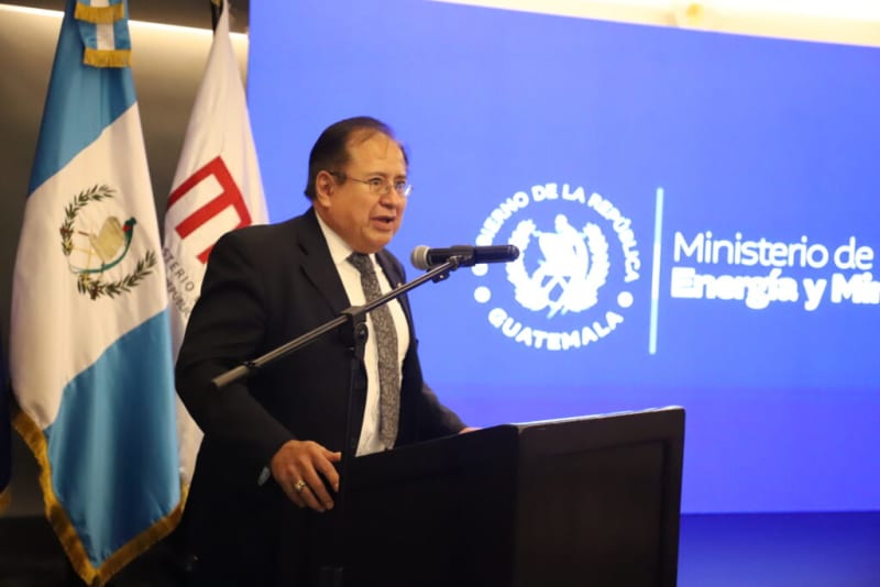 Solar panels installed across Guatemalan landscape with volcanic mountains in background