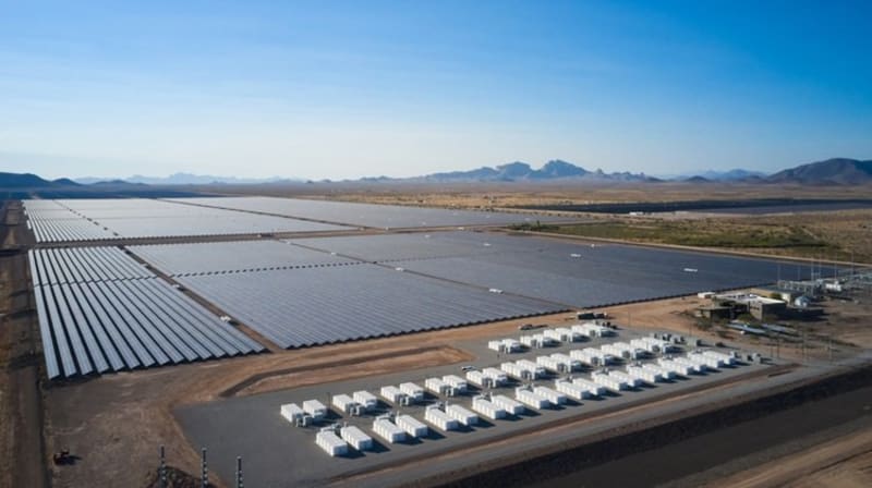 Vast solar panel array stretching across sunny Chilean desert landscape with mountains