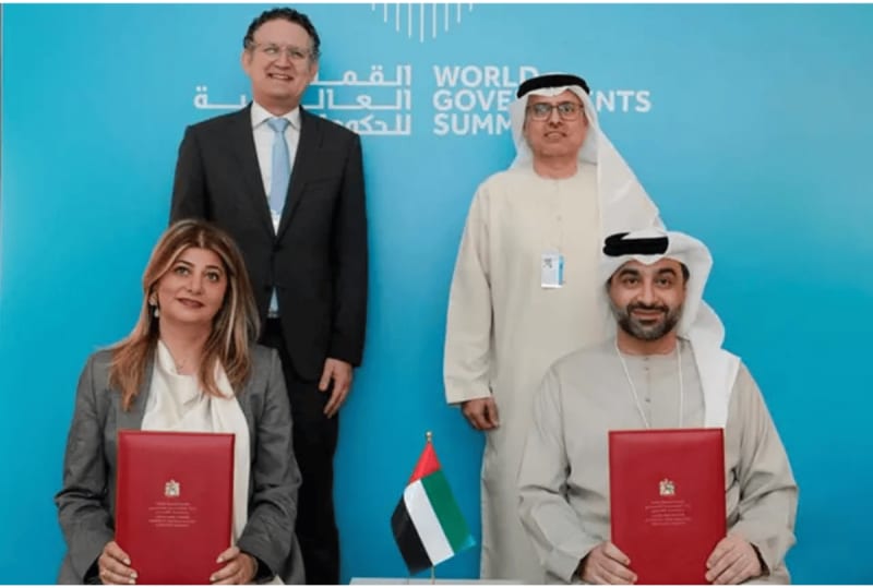 Students using tablet computers in modern UAE classroom with AI learning technology