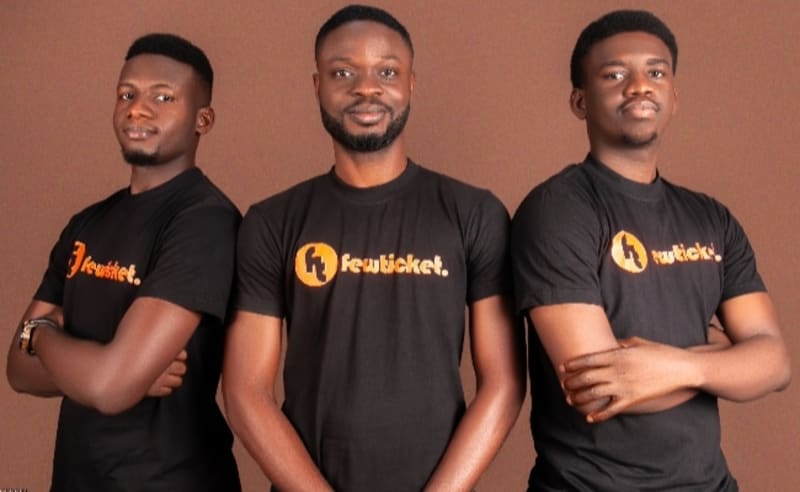 Crowd entering stadium gates using mobile phone QR code tickets at African music festival