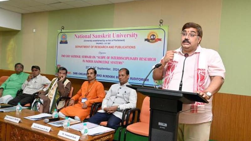 Indian university students studying ancient Sanskrit texts alongside modern textbooks in bright classroom