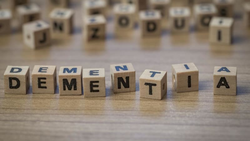 Young medical student in India learning compassionate dementia care with elderly patient