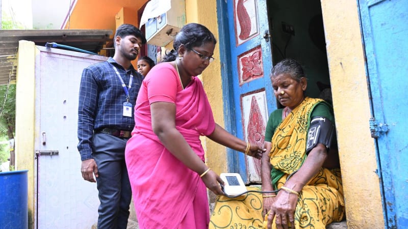 Healthcare worker visiting family home in Tamil Nadu India for health screening